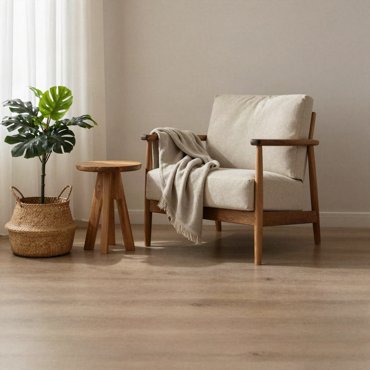 Warm neutral living room with linen armchair, woven basket and faux plant