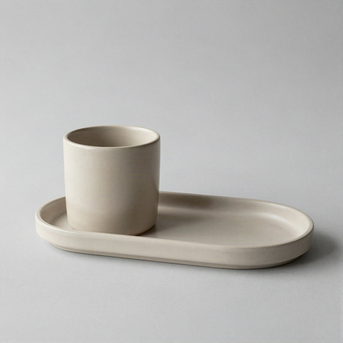 Ceramic tumbler and tray set on a counter