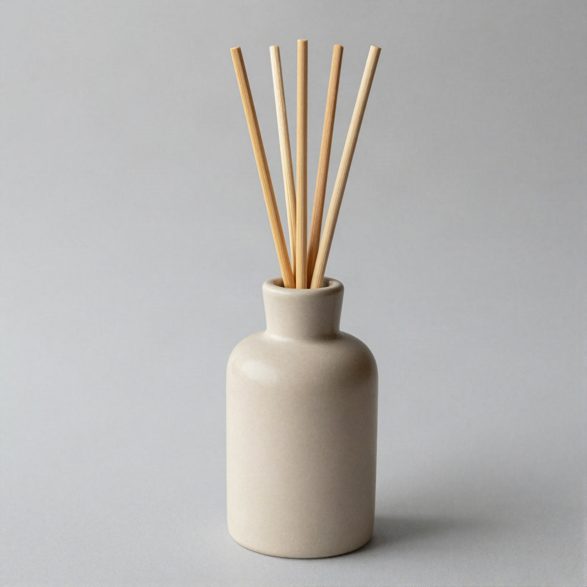 Ceramic reed diffuser on a side table